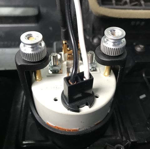1995 Ford Bronco - A close-up view shows the rear of a gauge, likely for a 1995 Ford Bronco, with wiring harness and mounting hardware visible.