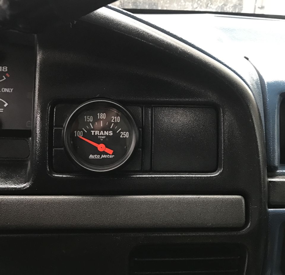 Close-up of a transmission temperature gauge on a vehicle dashboard.