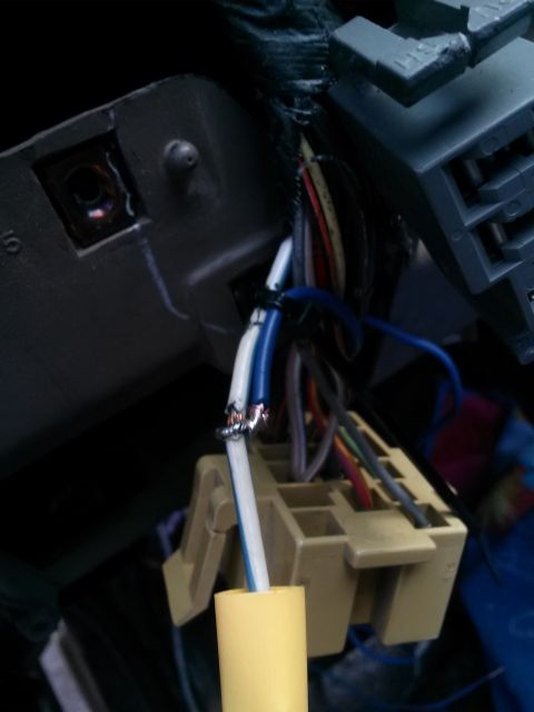 1996 Ford Bronco - Close-up view of wiring harness connectors and spliced wires, likely from a vehicle's dashboard or interior.