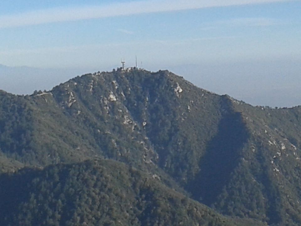 Mountain range with communication towers on summit.