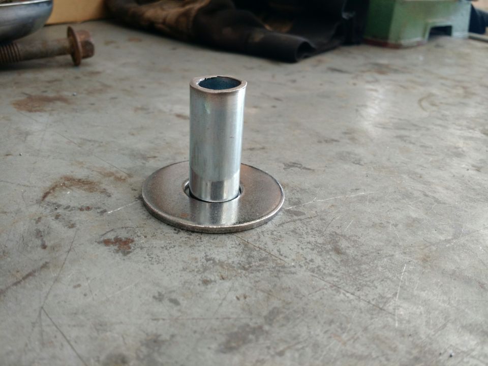 Metal cylinder on washer on textured surface
