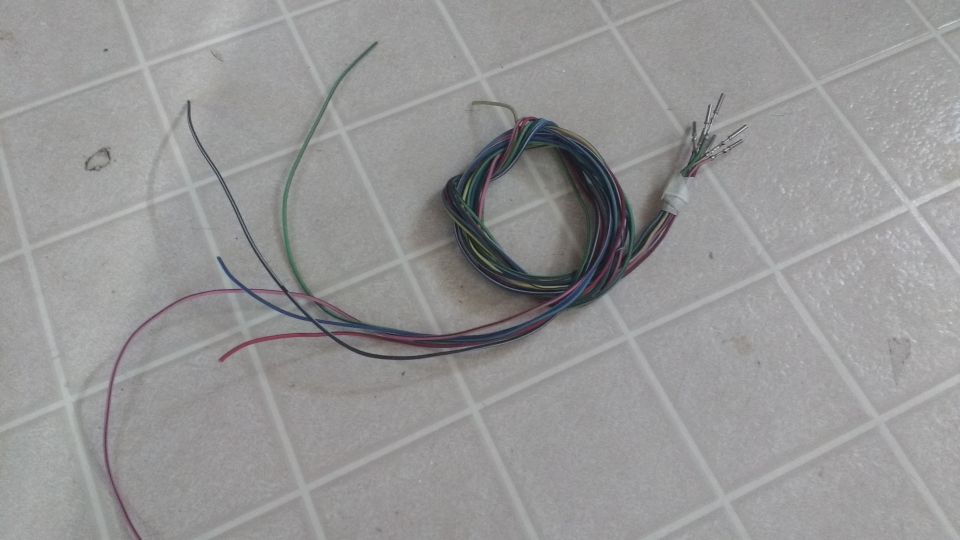 Bundle of multi-colored wires on a tiled surface