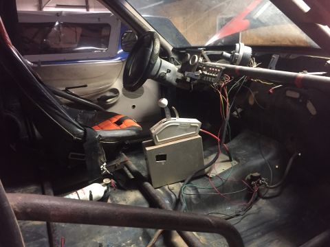 1982 Ford Bronco - The interior of a modified vehicle, likely a race car or off-road vehicle, shows a racing seat, a steering wheel, and exposed wiring. A fir…