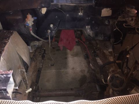 1982 Ford Bronco - This is an overhead view of the engine bay of a vehicle that appears to be undergoing some form of modification or repair. Visible componen…