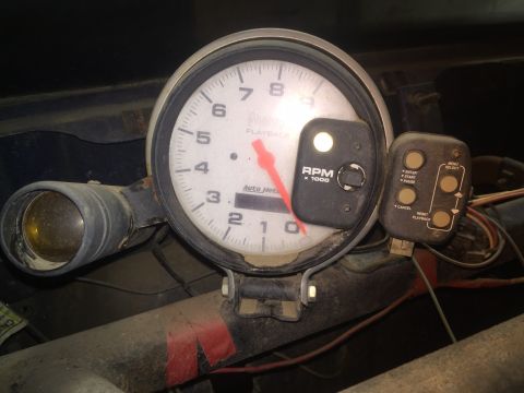 1982 Ford Bronco - A close-up view of a tachometer gauge in what appears to be a vehicle's interior. The gauge has a white face with black markings and a red…