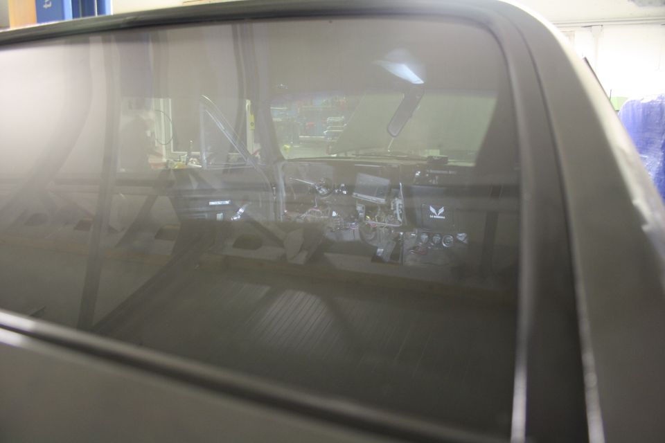 Interior of a classic car, showing dashboard and steering wheel.