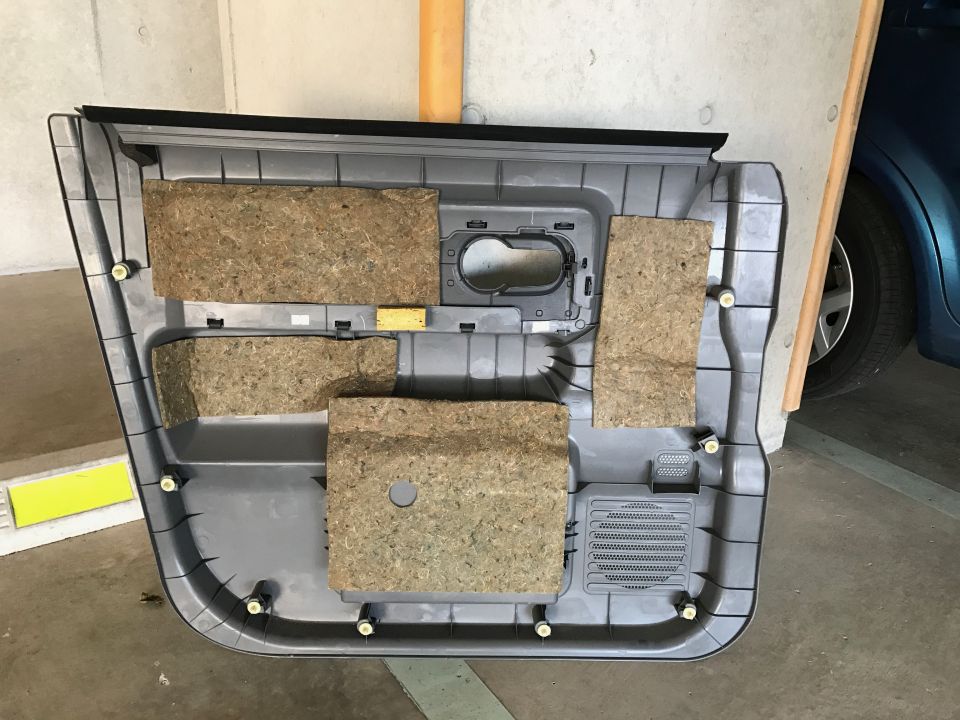 Interior of a car door panel with sound dampening material