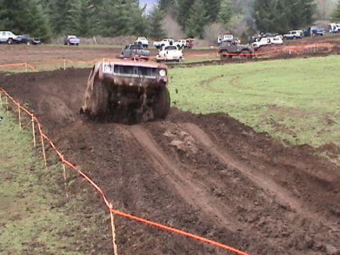 1994 Ford Explorer - A truck navigates a muddy track during an off-road event.