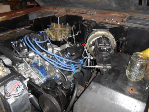 1972 Ford Bronco - The engine bay of a classic vehicle, likely a 1972 Ford Bronco, is shown with a V8 engine, carburetor, brake booster, and master cylinder v…