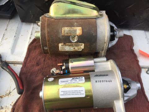 1979 Ford Bronco - Two remanufactured starters are shown, one older NAPA Power Premium starter and a newer ACDelco starter. The starters are laid out on a bro…