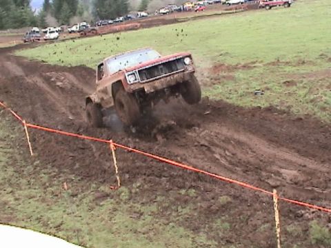 1994 Ford Explorer - A truck navigates a challenging mud course during an off-road event.