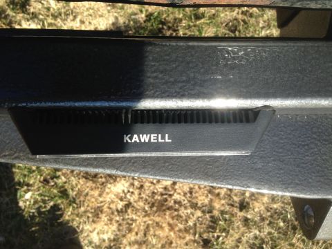 1979 Ford Bronco - A close-up view shows a black metal component with the white text "KAWELL" on it, mounted to a textured black metal frame. The background c…