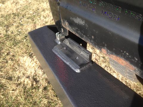 1979 Ford Bronco - A close-up view of a black aftermarket bumper with a metal bracket attached, mounted to the rear of a vehicle. Text is visible on the vehic…