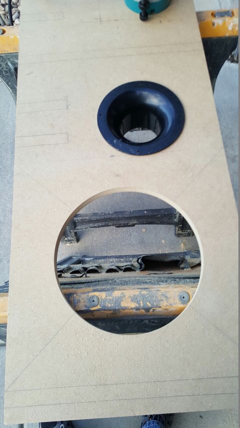 1996 Ford Bronco - A custom speaker enclosure is being built, with cutouts revealing the seat frame of a vehicle.