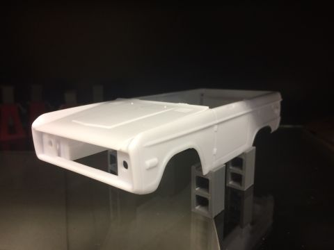 1989 Ford Bronco - Unpainted model of a first-generation Ford Bronco body, shown from the front-right quarter.