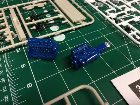 1989 Ford Bronco - Model engine parts and sprues laid out on a cutting mat, ready for assembly.