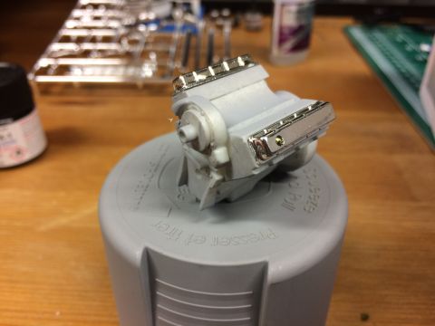 1989 Ford Bronco - A model engine sits on a gray plastic cap, likely part of a hobby project.