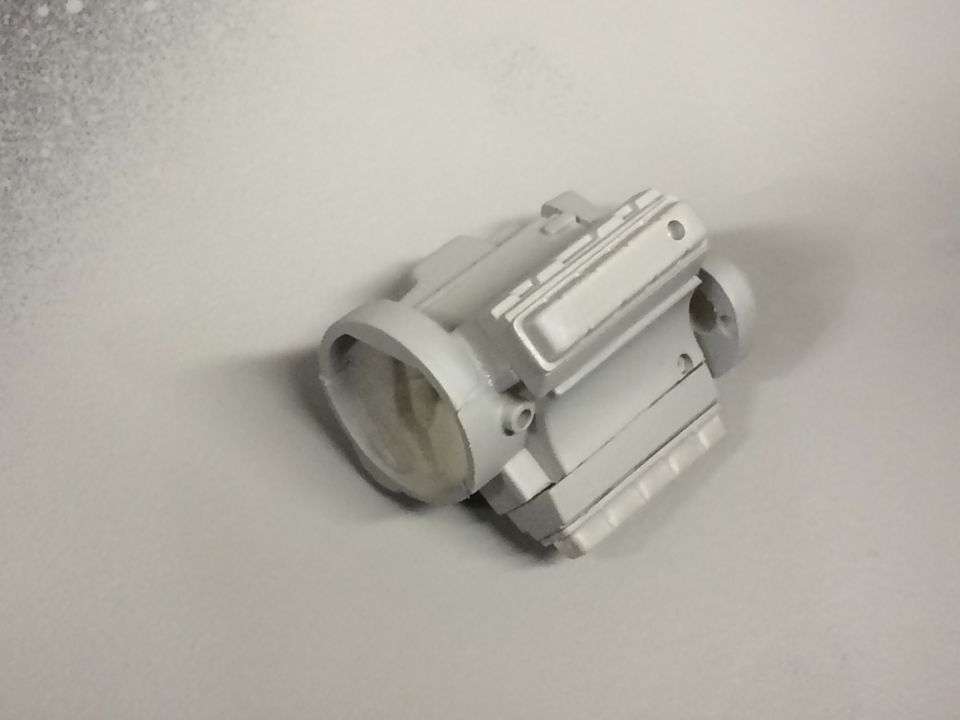 Gray engine part on a white surface