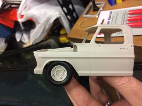 1989 Ford Bronco - Unassembled plastic model kit of a 1960s Ford F-series truck cab and fender.
