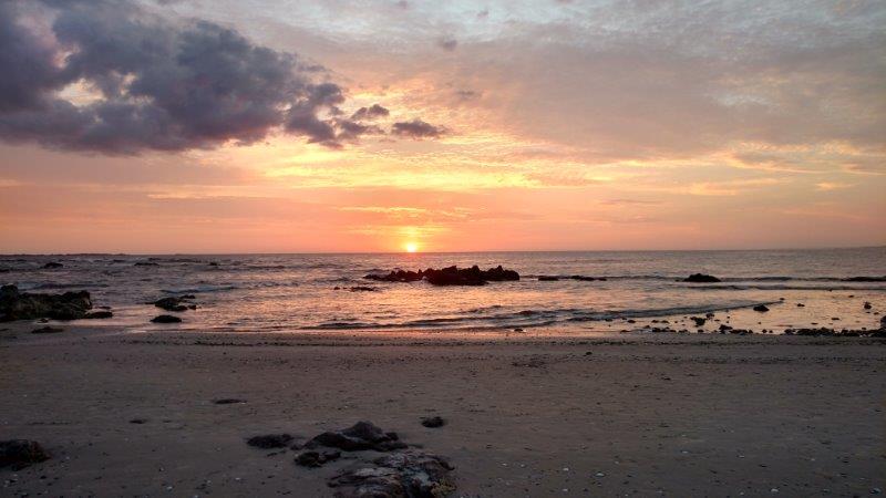 Sunset over a rocky ocean beach