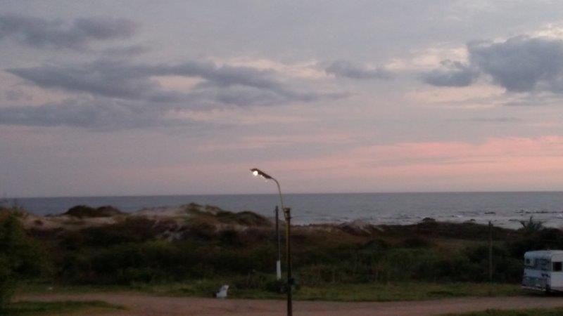 Dusk seascape with a lit street lamp and an RV