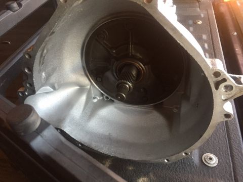 1982 Ford Bronco - A close-up view of the interior of a transmission bell housing, showing the input shaft splines and part of the torque converter. The metal…