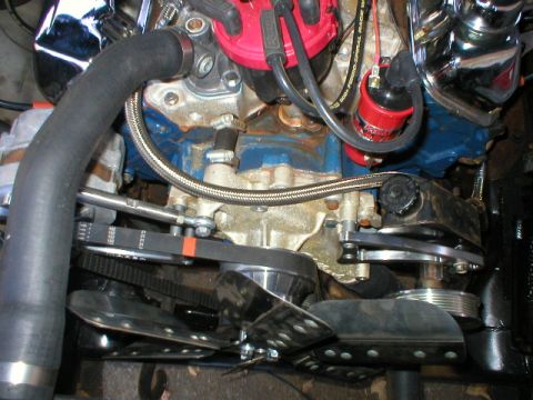 1978 Ford Bronco - Close-up view of an engine bay, showing various components like the distributor, hoses, and belts.
