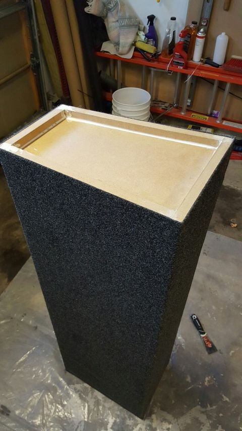 1996 Ford Bronco - A dark cabinet with a light-colored wooden surface is shown in a dimly lit room.