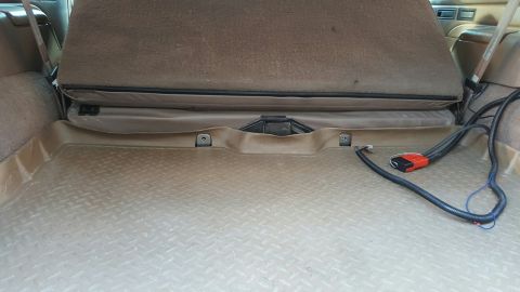 1996 Ford Bronco - The interior cargo area of a 1996 Ford Bronco features a tan diamond plate rubber floor mat. A folded rear seat is visible above the mat, w…