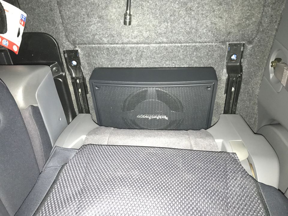 Black Rockford Fosgate subwoofer in a car's cargo area