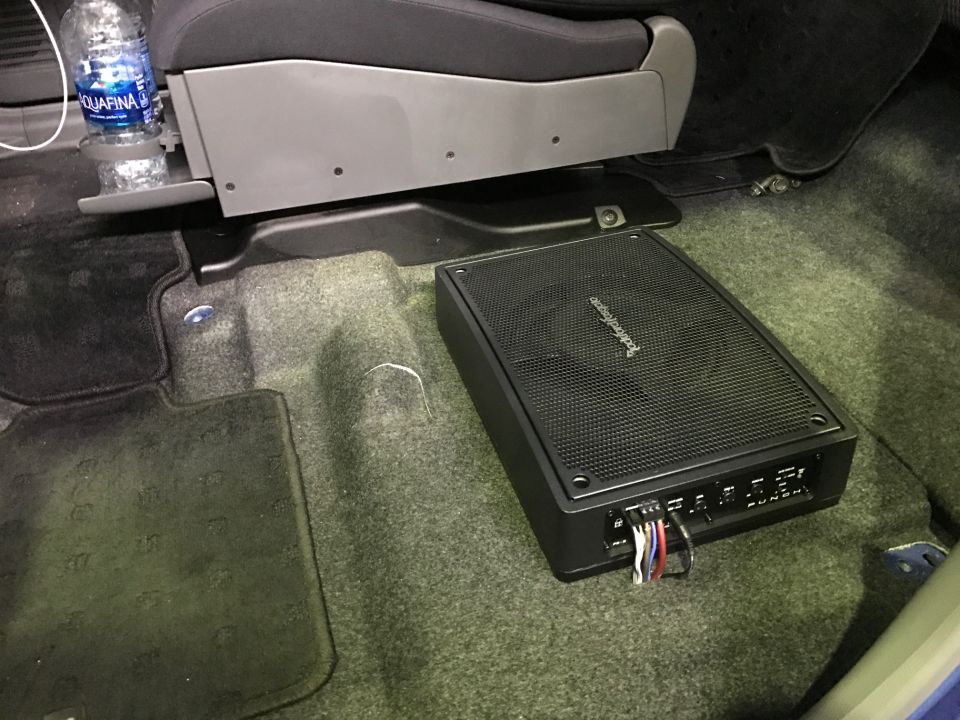 Aftermarket amplifier on vehicle floor