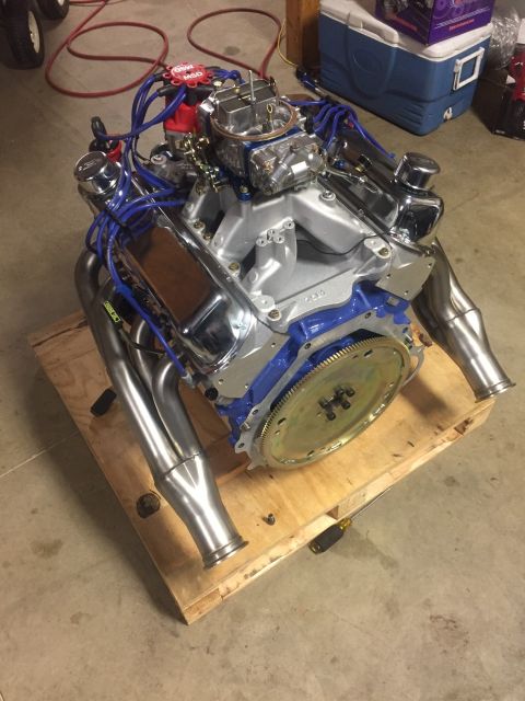 1982 Ford Bronco - A custom V8 engine with chrome valve covers and headers sits on a wooden pallet. The engine features a blue block, a silver intake manifold…
