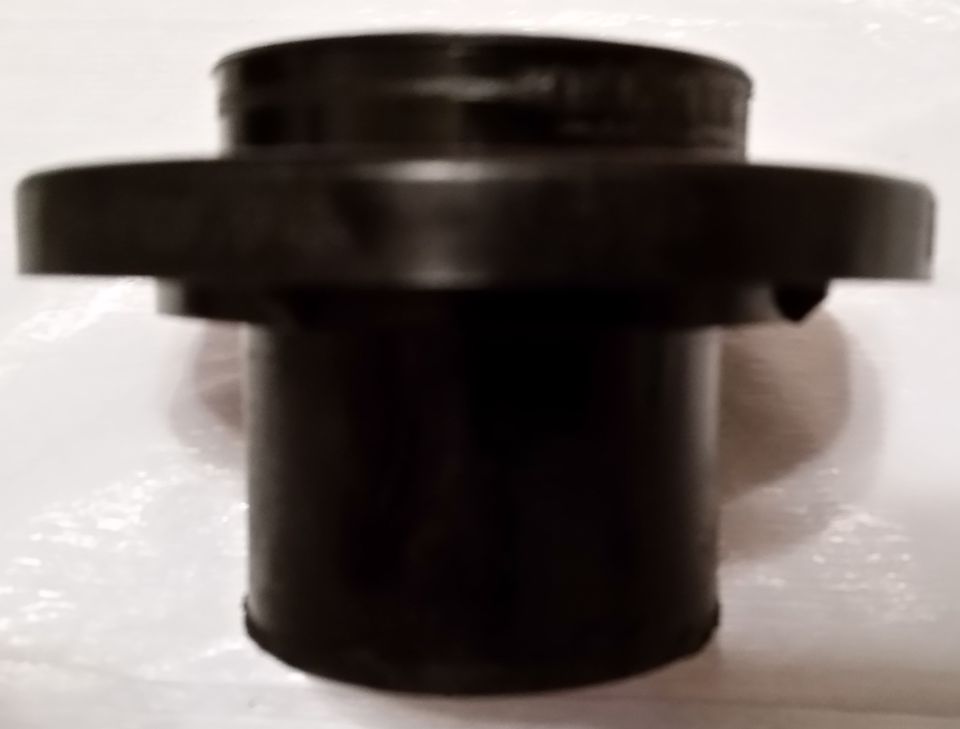 This is the piston.  Well, its less of a piston than an extension of the piston.  I'm going to call it a "piston follower".  The actual piston is a rubber ring.  This piece sits on top of the rubber ring and transfers force to the clutch release bearing, which in turn presses against the fingers in the pressure plate.  The bottom portion rests against the rubber piston seal, and the whole assembly is pushed out using hydraulic pressure when you step on the clutch.  Its hard to tell from these pictures, but notice that the bottom portion is not smooth, and instead is covered with burrs.  These burrs are solid, and are present around the entire base.  I've cut many pieces of plastic pipe in my day, and if I had to guess, these burrs are from the (lack of) machining process during construction.  The burrs are fused to the unit, which makes me assume that the factory uses (inadequate) heat to smooth the surface after cutting.