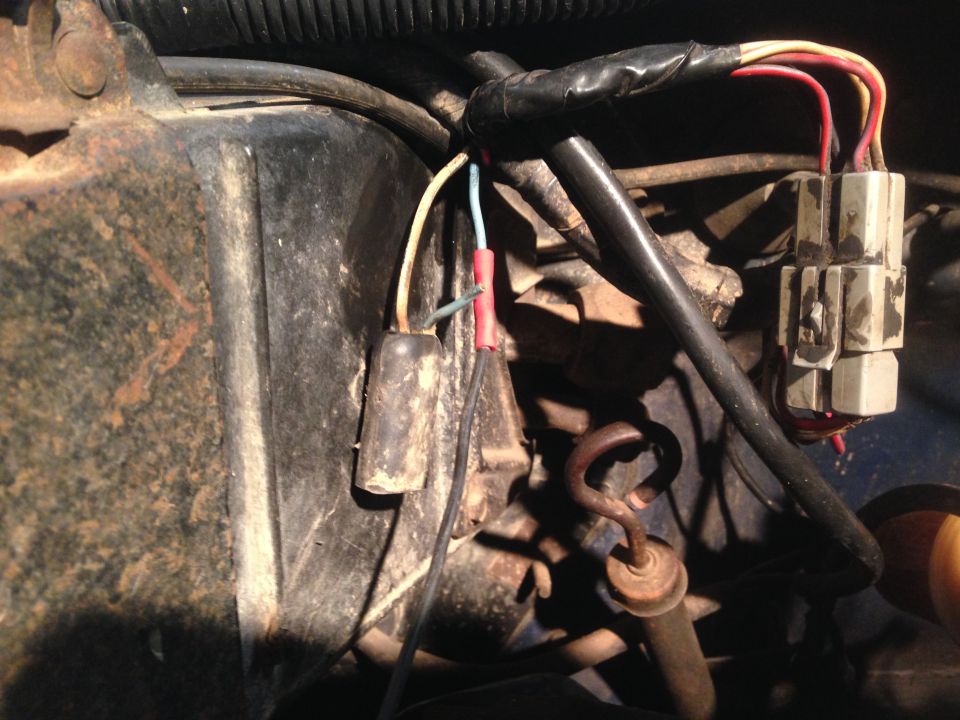 Engine wiring harness with connectors and a black cylindrical component.