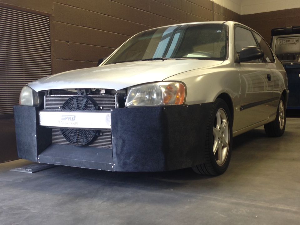 Silver 2001 Hyundai Accent hatchback with custom front bumper and fan