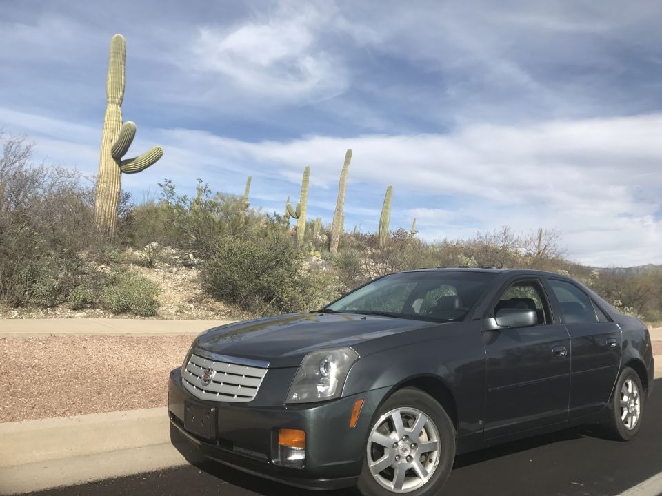 Dark gray 2007 Cadillac CTS sedan parked in a desert landscape with saguaro cacti.