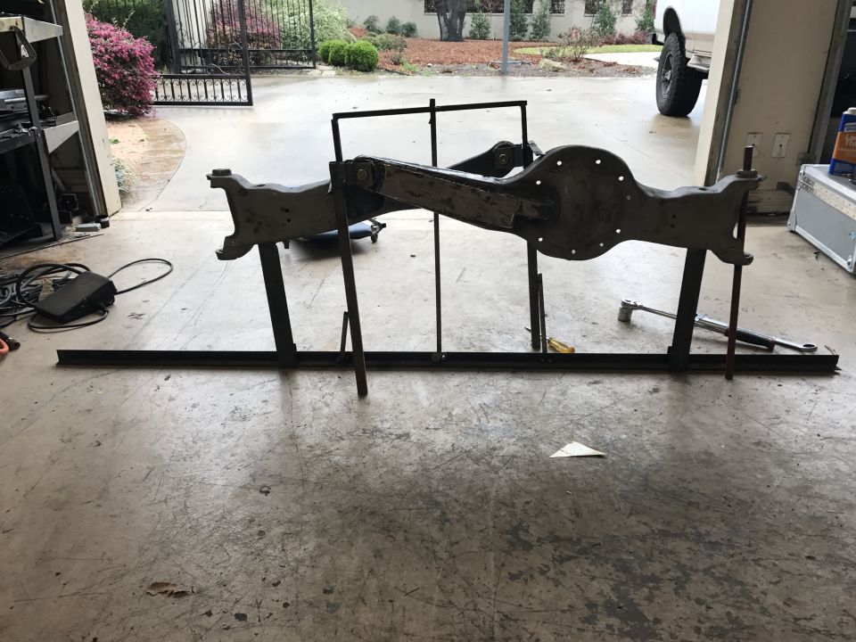 Ford Bronco front axle assembly on a stand in a garage