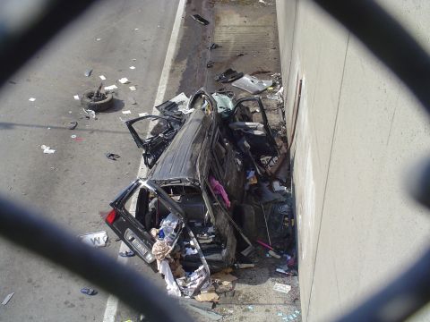 1971 Ford Ranchero - A severely damaged black SUV is shown after crashing into a concrete barrier.
