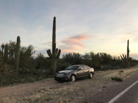 2007 Cadillac CTS - Cadillac CTS parked on a dirt road in the desert with saguaro cacti at sunset.