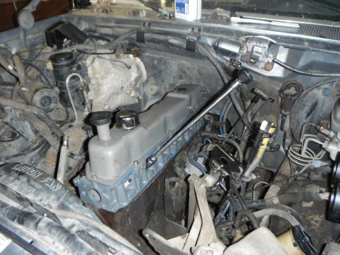 1995 Ford F-150 - Engine bay of a 1995 Ford F-150 with the valve cover removed for maintenance or repair.