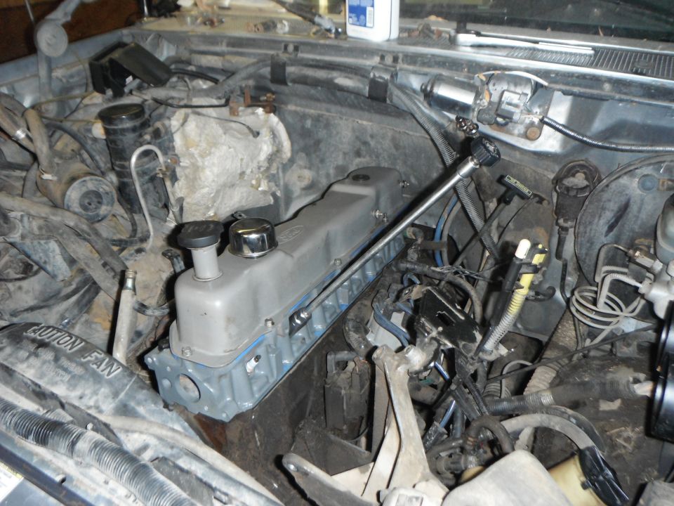 1995 Ford F-150 engine bay, valve cover removed, showing internal engine components and wiring