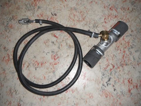 1990 Ford Bronco - A custom-made plumbing assembly with a braided hose and a brass fitting is laid out on a speckled countertop.
