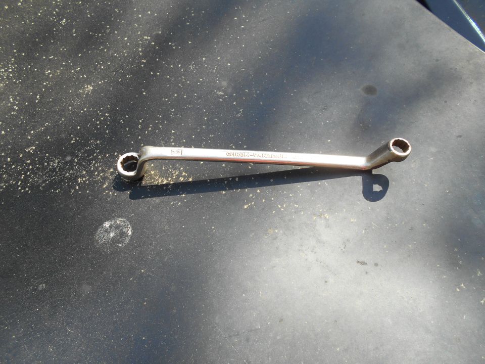 Silver wrench with text "CHROME-VANADIUM" on a dark surface.