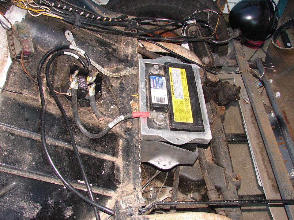 Vehicle battery and wiring with a black relay.