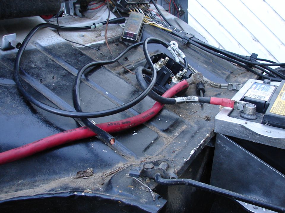 Car battery with red and black cables connected.