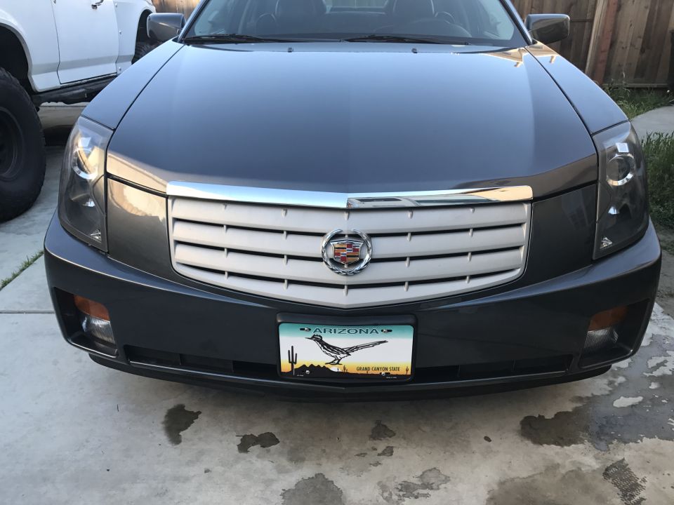 Front view of a dark gray Cadillac sedan with an Arizona license plate.