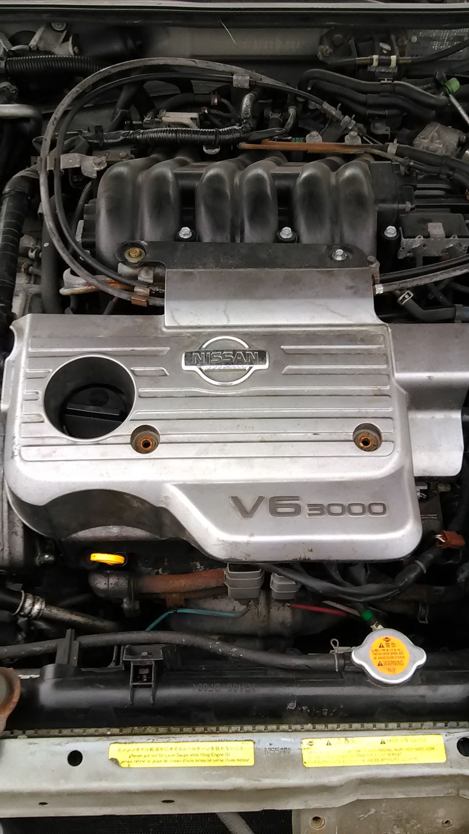 Nissan V6 3000 engine bay with silver intake plenum cover