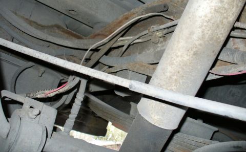 1992 Ford Bronco - The routing of the mystery box's red wire before it splices into the rear diff loom. Also pictured is an empty hose up high, which looks li…