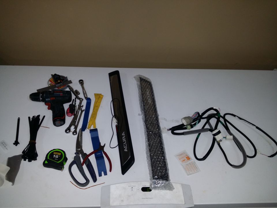 Tools and vehicle parts including a drill, pliers, scissors, tape measure, and wire harnesses.