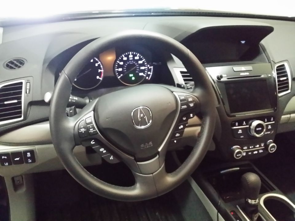 Interior of an SUV showing steering wheel, dashboard, infotainment screen, and center console.